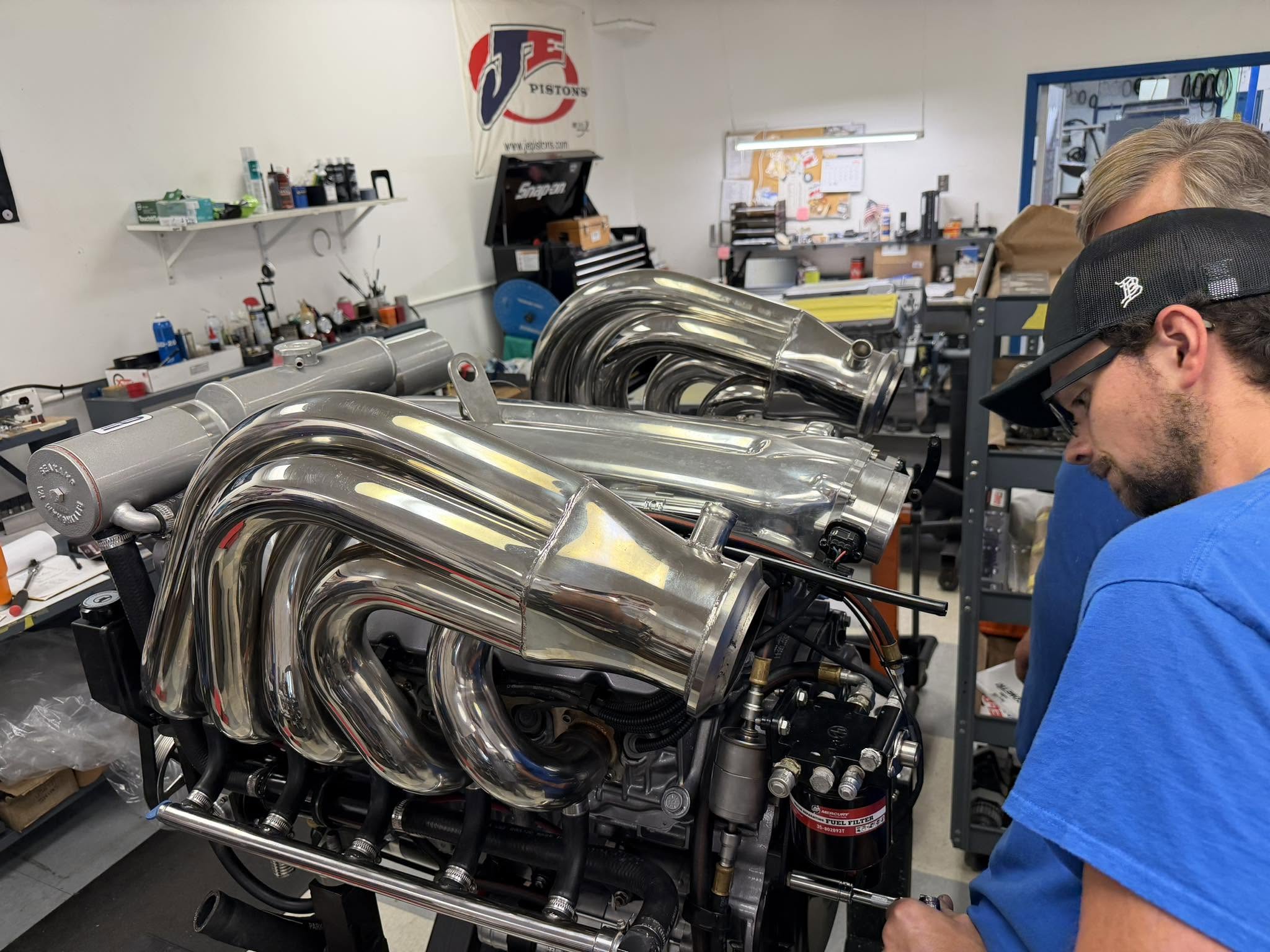 Boat engine rebuild, polished marine headers being hand-assembled